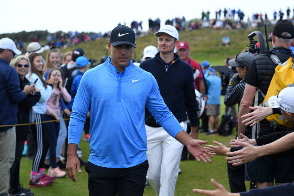 Brooks Koepka high fiving fans at The Open